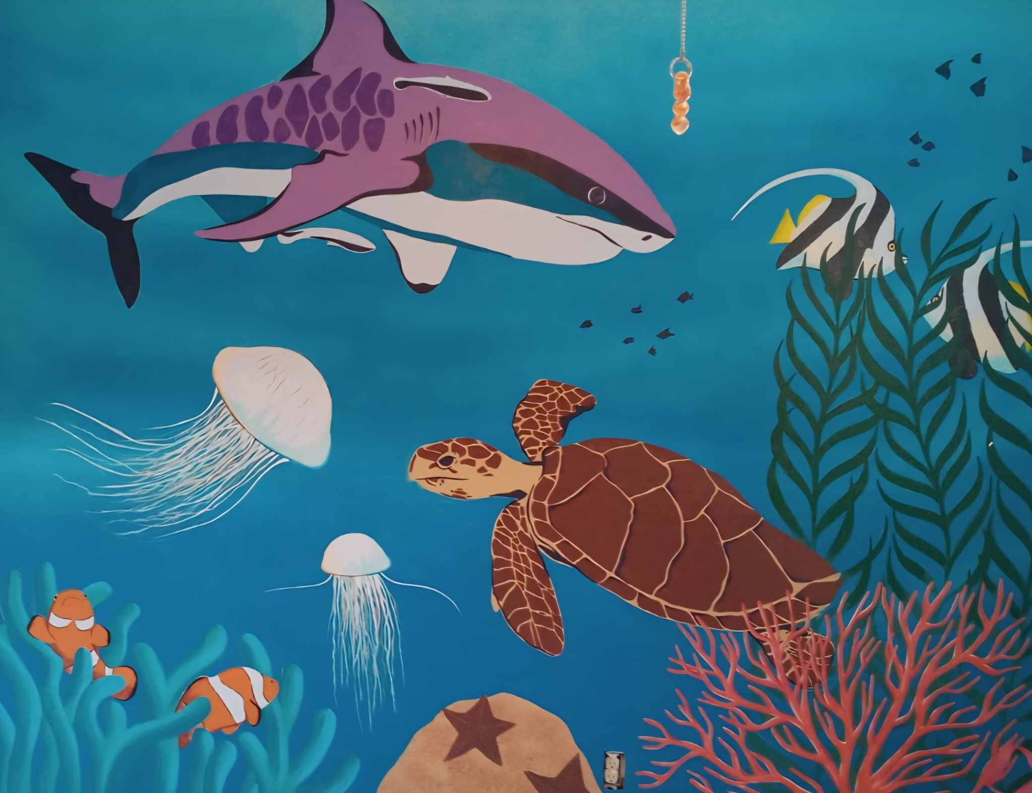 Underwater reef mural with a shark, sea turtle, jellyfish, and tropical fish